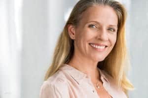 Mature smiling woman in pink