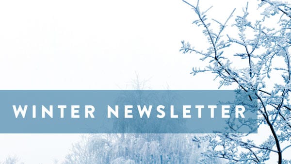 "Winter Newsletter" written in front of a frosted trees background. 